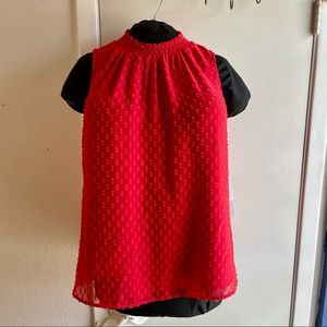 Smocked red sleeveless blouse.